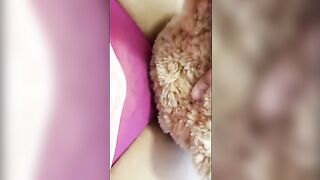 The girl is having fun with her teddy bear in a naughty way
