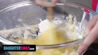 Two stepdaughters are busy with a kitchen task for their dads