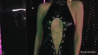 A skinny teen, AngelQ, strips on stage wearing high heels and black lingerie