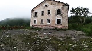 A sexy babe is walking around horrible buildings in a daring act