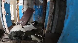A sexy babe is walking around horrible buildings in a daring act