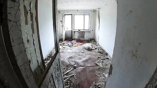 A sexy babe is walking around horrible buildings in a daring act