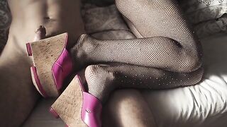 A hot girl in fishnet stockings and high heels is waiting for her partner