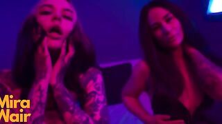 Two girls in dresses have fun with a man together
