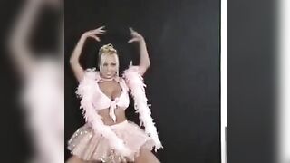 A cute Russian girl is dancing and stripping in the kitchen