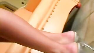 Beautiful brunette masturbating on a leather chair