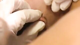 A girl with a pierced clitoris plays with sex toys and rubs herself