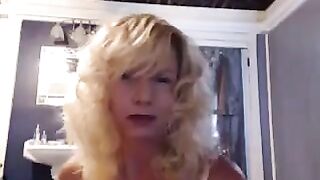 A mature woman plays with herself in the bathroom with a vibrator