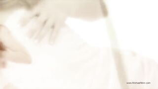 A young and pretty woman masturbates passionately, showcasing her seductive allure