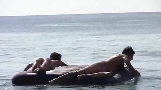 A girl sunbathes naked on the beach, showing her body in HD quality