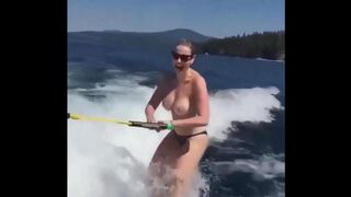 A sexy girl is having fun on the water with her skis