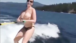 A sexy girl is having fun on the water with her skis