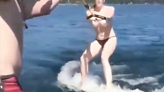 A sexy girl is having fun on the water with her skis