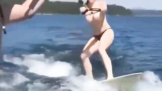 A sexy girl is having fun on the water with her skis