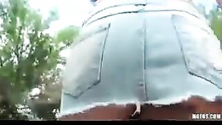 Finger-fucking brunette with small tits in the middle of the street