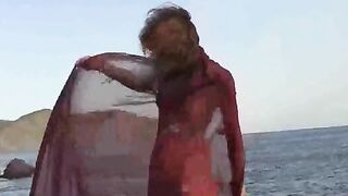 A sexy girl with small boobs gets them wet in the river