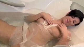 A lonely brunette woman caresses herself in the shower