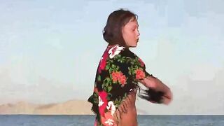 The member shows the girl in a nude beach scene