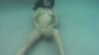 Sex in the ocean with a busty brunette woman