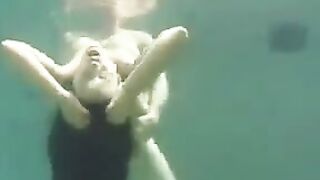 Sex in the ocean with a busty brunette woman