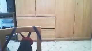A woman fucks in front of her webcam, her husband is nearby