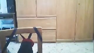 A woman fucks in front of her webcam, her husband is nearby