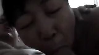 An adult Chinese woman practices her blowjob skills