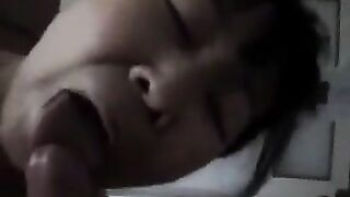 An adult Chinese woman practices her blowjob skills