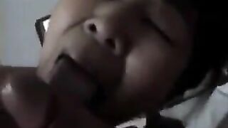 An adult Chinese woman practices her blowjob skills