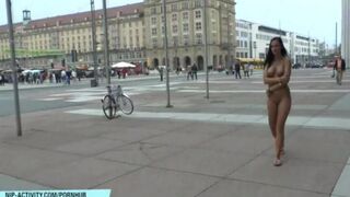 A young naked girl is walking the streets of the city in this hot video