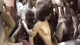 A young slut in stockings is having fun with a bunch of guys