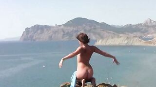 A naked girl is having fun on the beach