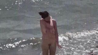 A couple of nudists enjoying their time on the beach