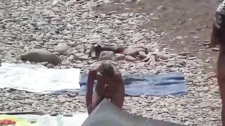A couple of nudists enjoying their time on the beach