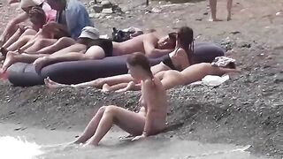 A couple of nudists enjoying their time on the beach