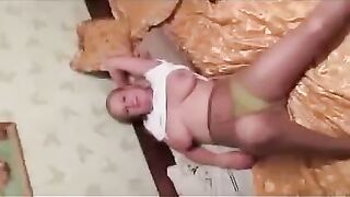 A pregnant woman is leaking milk in front of a photographer