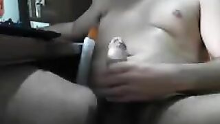 Guy sits in front of computer and masturbates his dick with his hand
