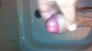 The kid caresses his dick in the shower, imitating sex with a girl