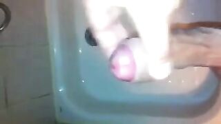 The kid caresses his dick in the shower, imitating sex with a girl