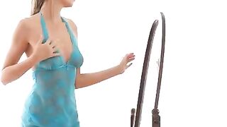 A hot chick is doing her stretching exercises in front of the mirror