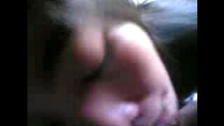 Careful Chinese girl sucks her boyfriend's dick by the bed