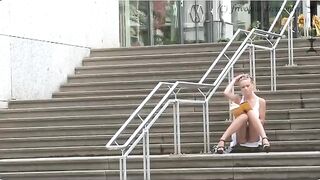A girl walks on the street without panties, her ass is being filmed