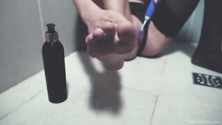 In the shower, a naked beauty plays with sex toys and gets wet