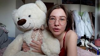 A cute girl has fun with her favorite teddy bear