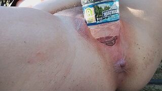 A beautiful woman reaches the peak of pleasure while masturbating outdoors