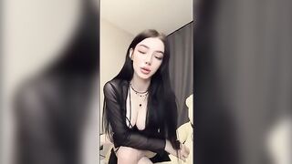 The girl playfully shows her holes to the camera, showcasing her goth vibe