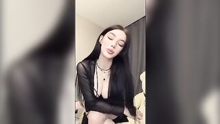 The girl playfully shows her holes to the camera, showcasing her goth vibe