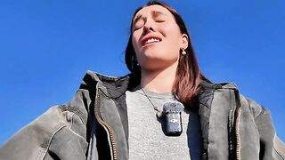 A petite brunette babe masturbating on a public beach